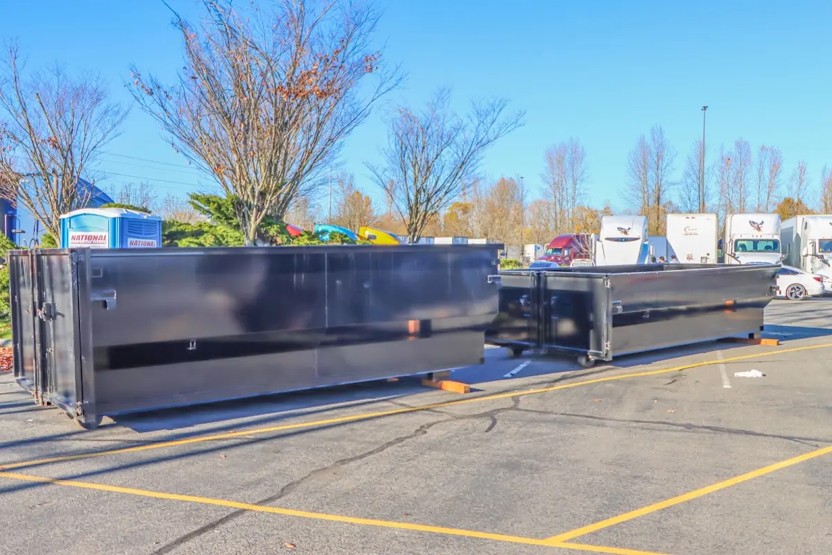 Professional dumpster rental service with roll-off container on residential driveway in North Fond du Lac